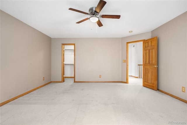unfurnished room with baseboards, light colored carpet, and ceiling fan