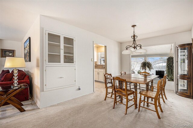 dining area featuring light carpet