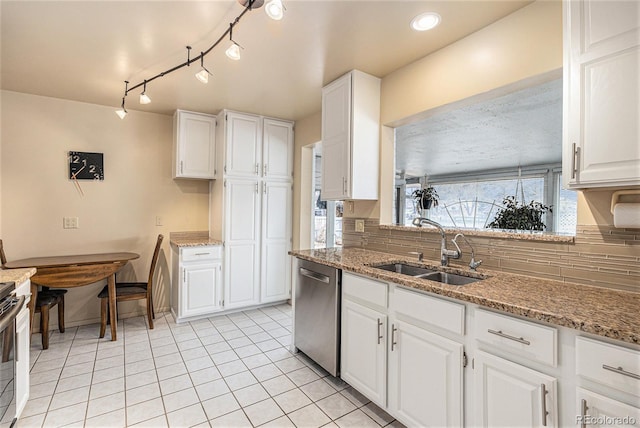 kitchen with tasteful backsplash, dishwasher, light stone countertops, white cabinetry, and a sink