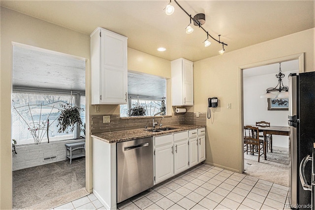 kitchen featuring white cabinetry, stainless steel appliances, and light colored carpet