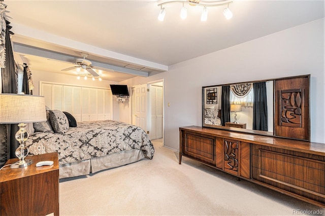 bedroom featuring carpet floors, a ceiling fan, and beamed ceiling