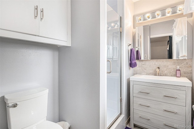 full bath featuring toilet, backsplash, a shower stall, and vanity