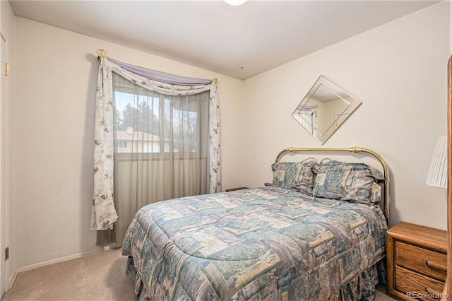 carpeted bedroom featuring baseboards