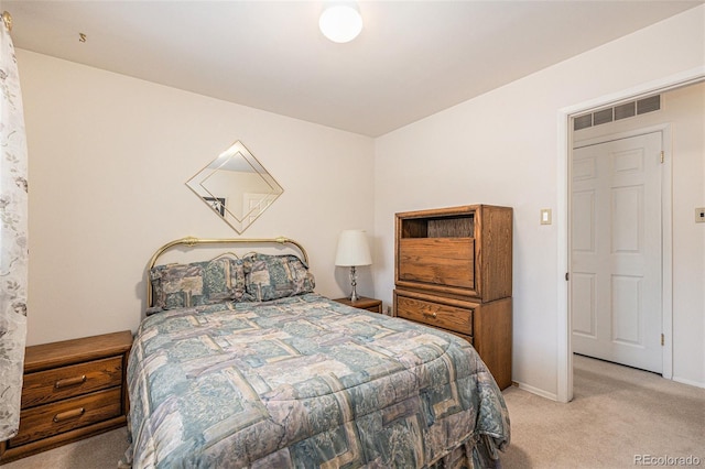 bedroom featuring light carpet, baseboards, and visible vents