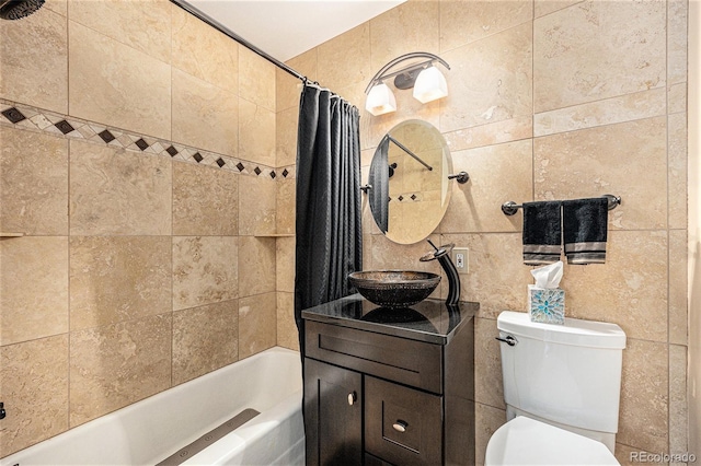 bathroom featuring tile walls, vanity, toilet, and shower / bathtub combination with curtain