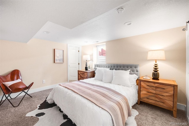 carpeted bedroom with baseboards and a textured ceiling