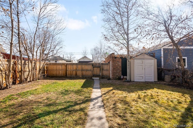 view of yard featuring a storage shed, a fenced backyard, and an outdoor structure