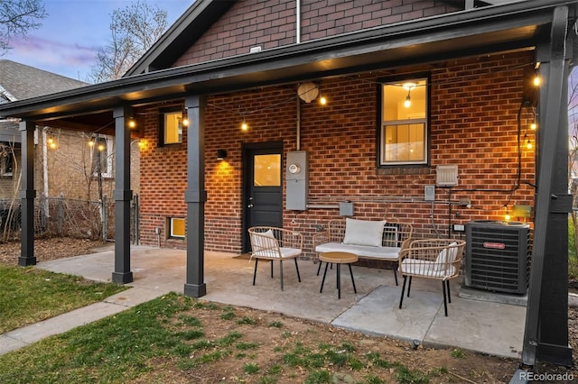 view of patio with central AC unit and fence