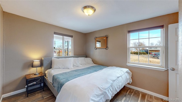 bedroom with dark hardwood / wood-style floors