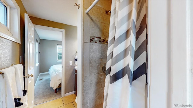 bathroom with tile patterned floors, a shower with shower curtain, and vanity