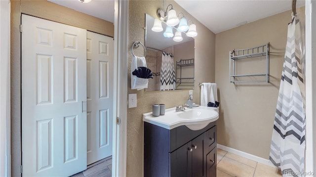 bathroom featuring vanity, tile patterned floors, and walk in shower