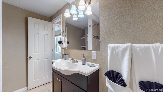 bathroom with vanity, tile patterned flooring, and a chandelier