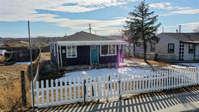 3282 W 66th Ave, Denver, CO 80221 - bungalow featuring a fenced front yard and roof with shingles