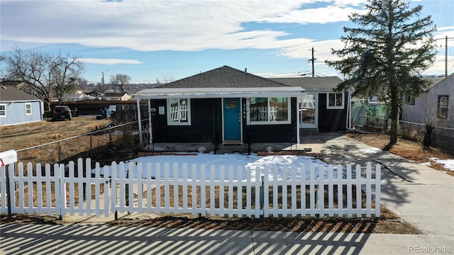 3282 W 66th Ave, Denver, CO 80221 - view of front of home with a fenced front yard and a shingled roof