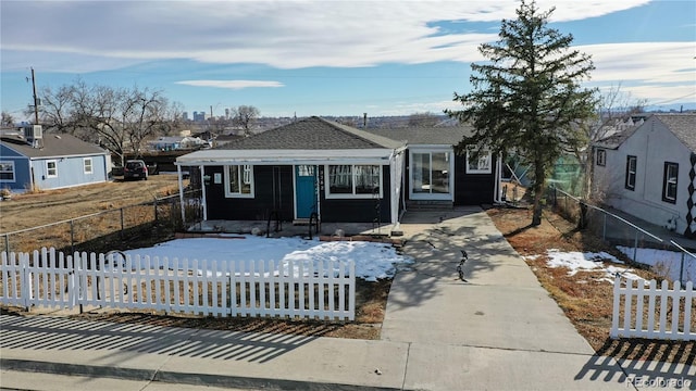 3282 W 66th Ave, Denver, CO 80221 - view of front of property with a fenced front yard and roof with shingles
