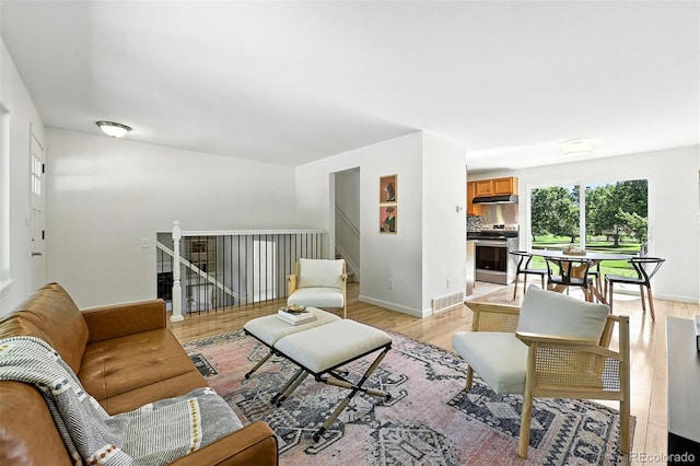 1380 Holly Dr E, Broomfield, CO 80020 - living area with light wood-style floors and stairway