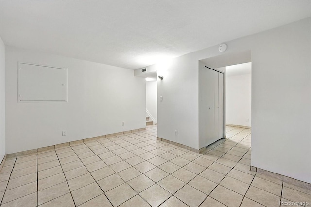 1380 Holly Dr E, Broomfield, CO 80020 - empty room with stairway, a smoke detector, and light tile patterned floors