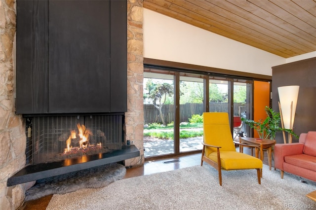 3650 Chimayo Rd, Littleton, CO 80123 - carpeted living room featuring wooden ceiling, lofted ceiling, and a stone fireplace