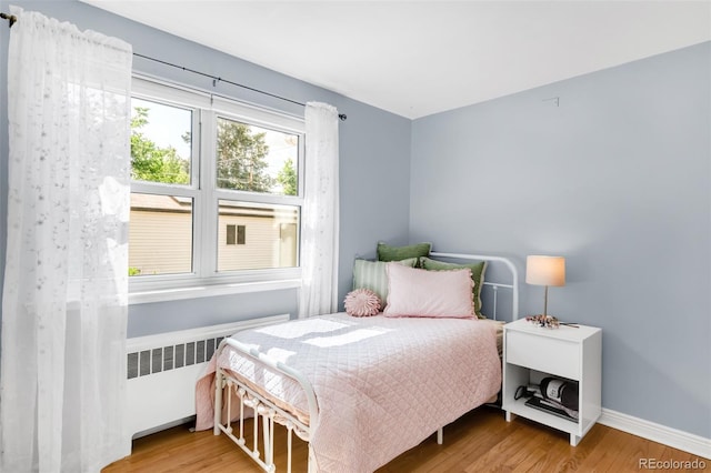 1185 Glencoe St, Denver, CO 80220 - bedroom featuring radiator and wood finished floors