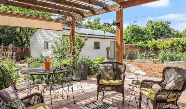 1185 Glencoe St, Denver, CO 80220 - view of patio with a vegetable garden, outdoor dining space, and a pergola