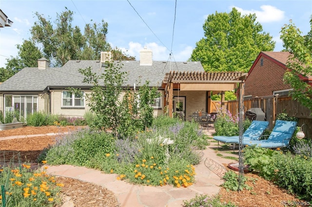 1185 Glencoe St, Denver, CO 80220 - back of property with a chimney, brick siding, a patio, and roof with shingles