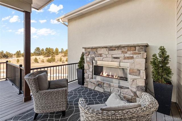 deck with an outdoor stone fireplace