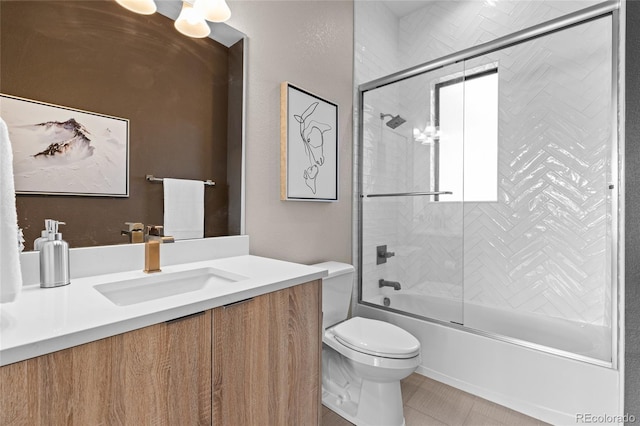 full bathroom featuring shower / bath combination with glass door, tile patterned floors, vanity, and toilet