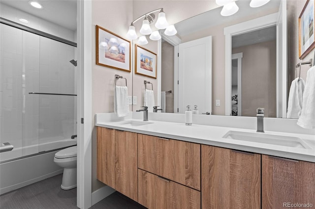 full bathroom with tile patterned floors, vanity, toilet, and shower / bath combination with glass door