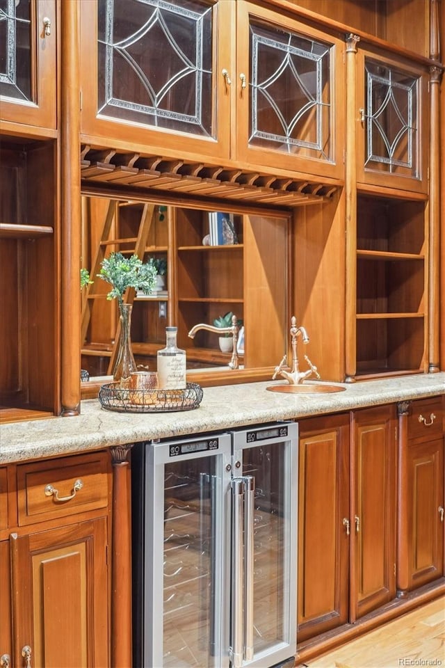bar featuring indoor wet bar, a sink, and wine cooler