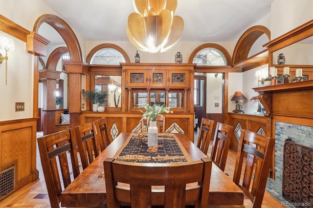 dining area featuring a wealth of natural light, a notable chandelier, wainscoting, and visible vents