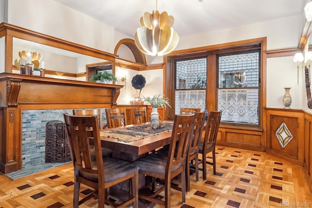 dining space featuring a notable chandelier and wainscoting