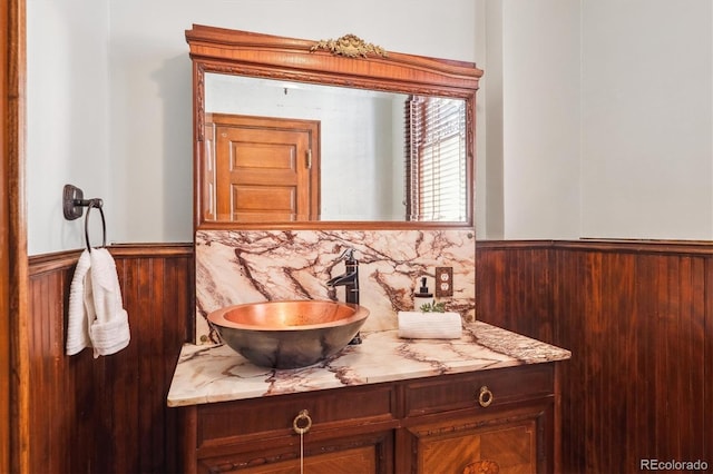 bathroom featuring vanity and a wainscoted wall