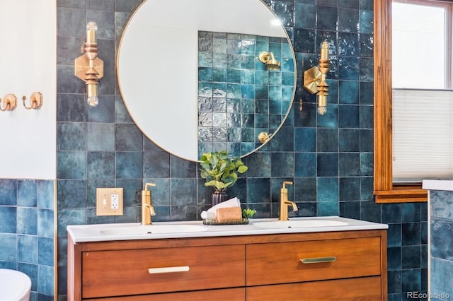 bathroom with double vanity, tile walls, and a sink
