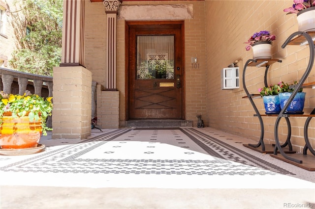 view of exterior entry with brick siding