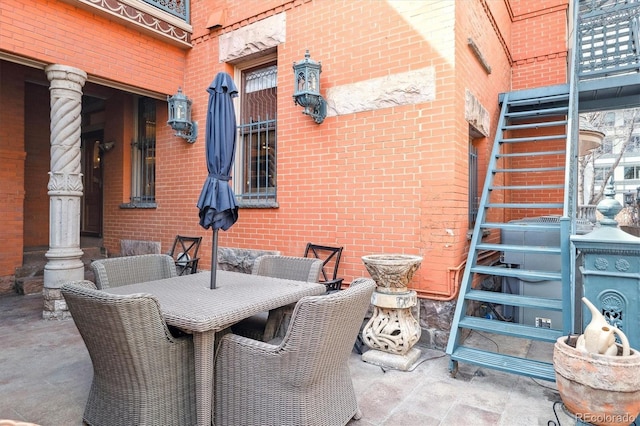 view of patio / terrace with outdoor dining area and stairs
