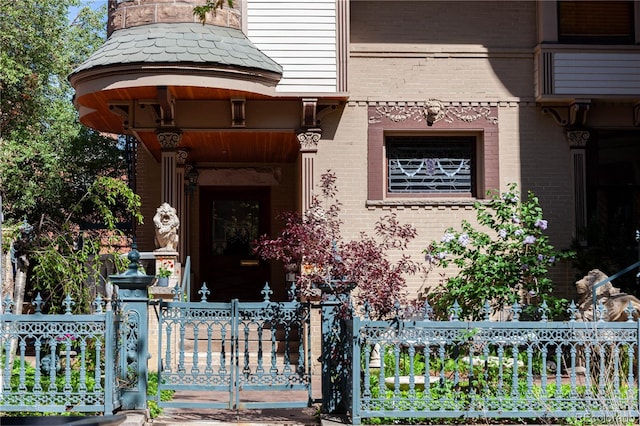 1022 N Pearl St Unit 101, Denver, CO 80203 - entrance to property featuring brick siding, fence, and a gate