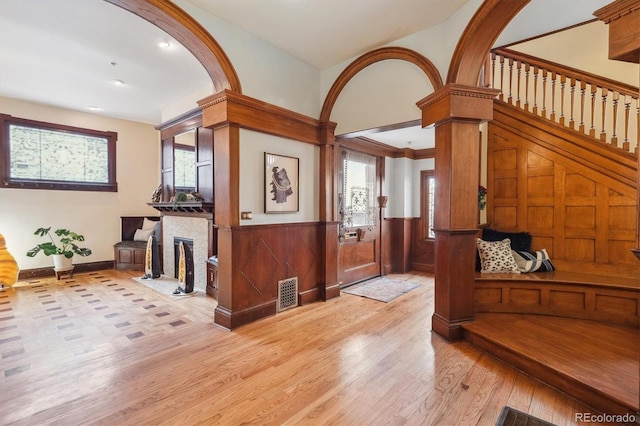 1022 N Pearl St Unit 101, Denver, CO 80203 - foyer with light wood-type flooring, a fireplace with flush hearth, a healthy amount of sunlight, and visible vents
