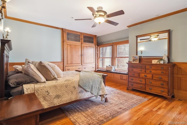 1022 N Pearl St Unit 101, Denver, CO 80203 - bedroom featuring wainscoting, ceiling fan, ornamental molding, and light wood-style flooring