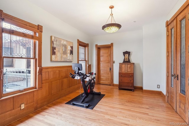 1022 N Pearl St Unit 101, Denver, CO 80203 - workout area with light wood-style flooring and a wainscoted wall