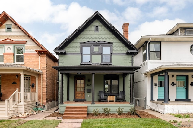 940 N Ogden, Denver, CO 80218 - view of front of house with brick siding, covered porch, and a chimney