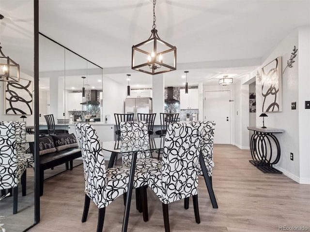800 N Pearl St Unit 1203, Denver, CO 80203 - dining area with light wood finished floors, a chandelier, and baseboards