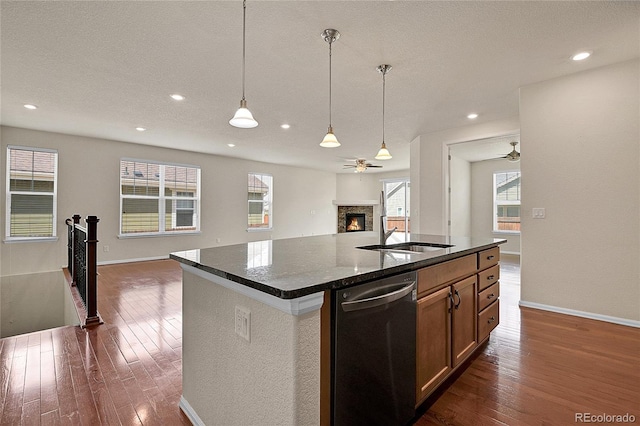 16076 Columbine Pl, Thornton, CO 80602 - kitchen with dishwasher, open floor plan, a sink, ceiling fan, and dark wood-style flooring