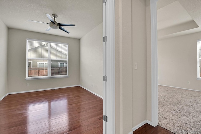 16076 Columbine Pl, Thornton, CO 80602 - unfurnished room featuring dark wood-type flooring, ceiling fan, baseboards, and a textured ceiling