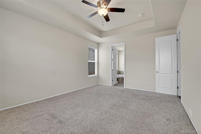 16076 Columbine Pl, Thornton, CO 80602 - unfurnished bedroom with carpet floors, baseboards, a tray ceiling, and ensuite bath