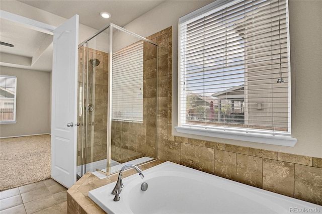 16076 Columbine Pl, Thornton, CO 80602 - bathroom with a stall shower, healthy amount of natural light, a garden tub, tile patterned floors, and recessed lighting