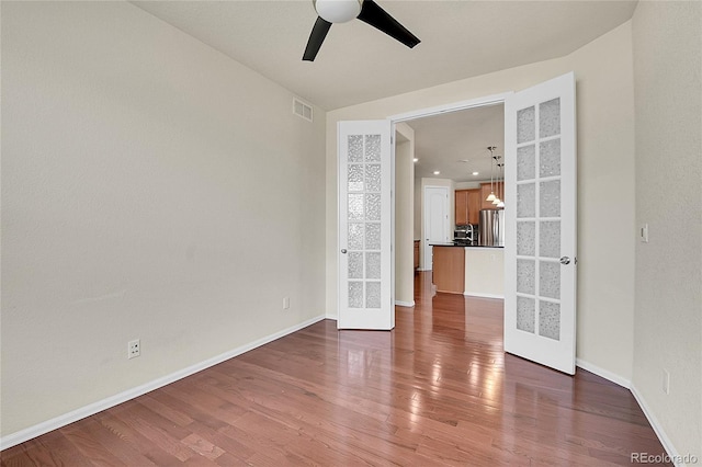 16076 Columbine Pl, Thornton, CO 80602 - empty room with french doors, a ceiling fan, wood finished floors, and baseboards
