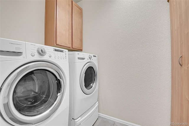 16076 Columbine Pl, Thornton, CO 80602 - laundry room with washing machine and dryer, cabinet space, light tile patterned flooring, and baseboards