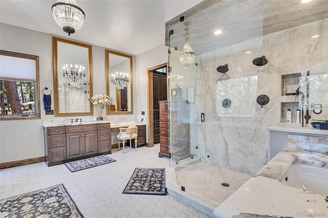 bathroom featuring walk in shower, vanity, and a chandelier