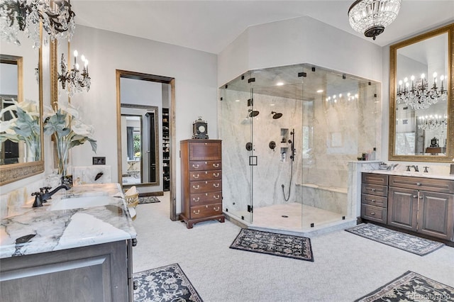 bathroom with vanity, a notable chandelier, and walk in shower