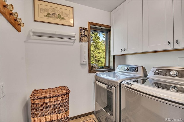 laundry room featuring cabinets and washing machine and clothes dryer